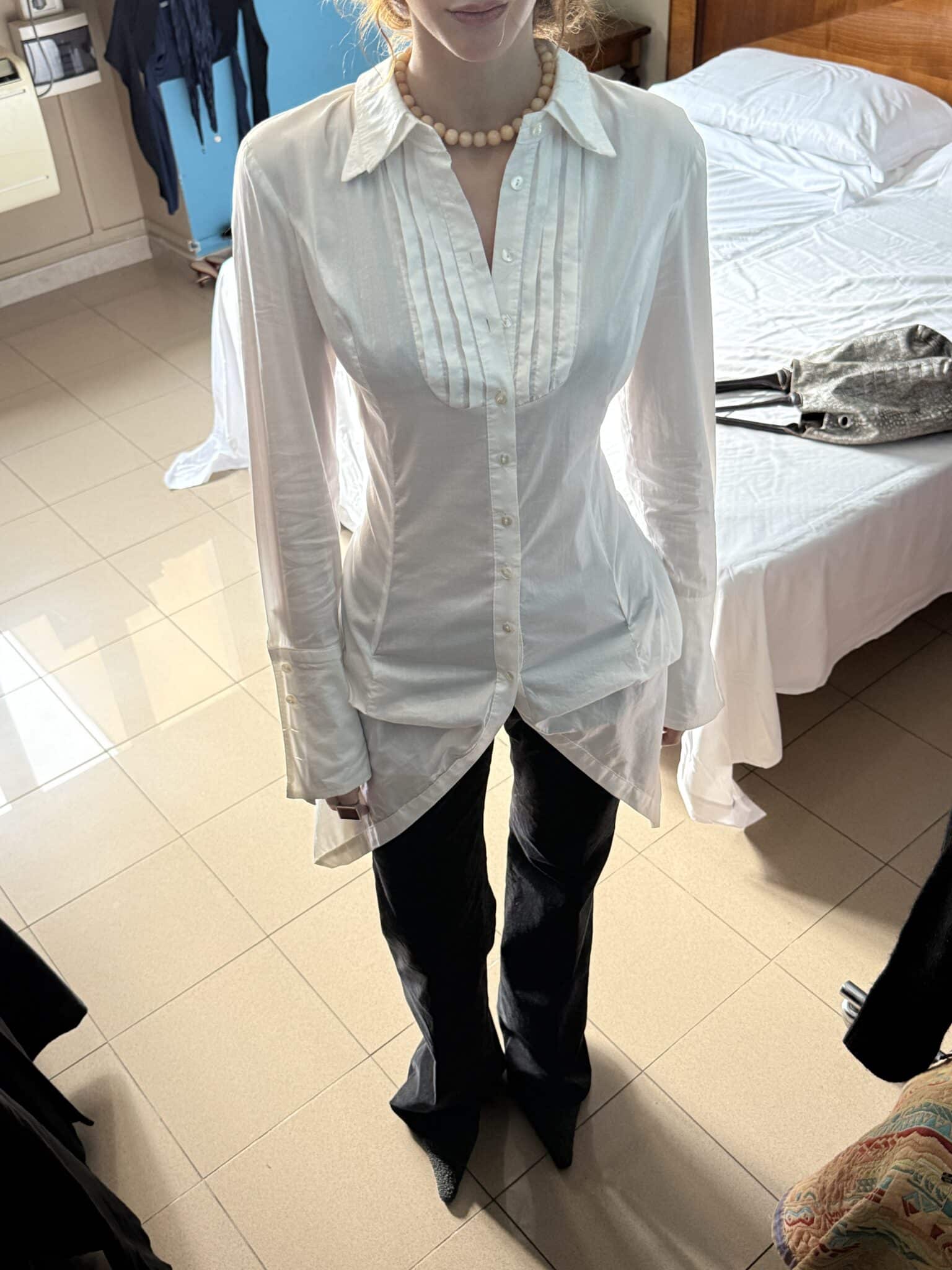 White cotton shirt styled with black minimalist trousers