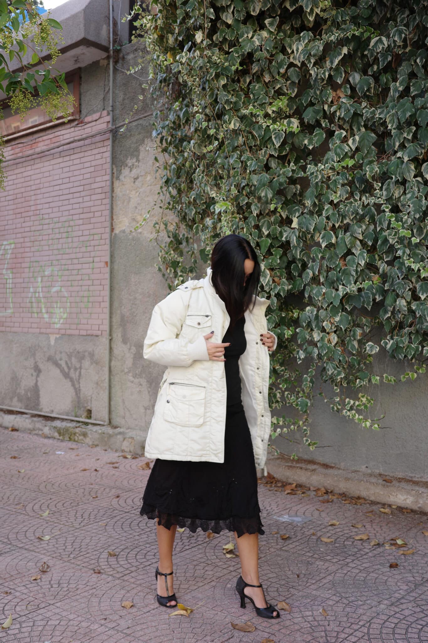 Black lace skirt outfit styled for cold-weather layering.