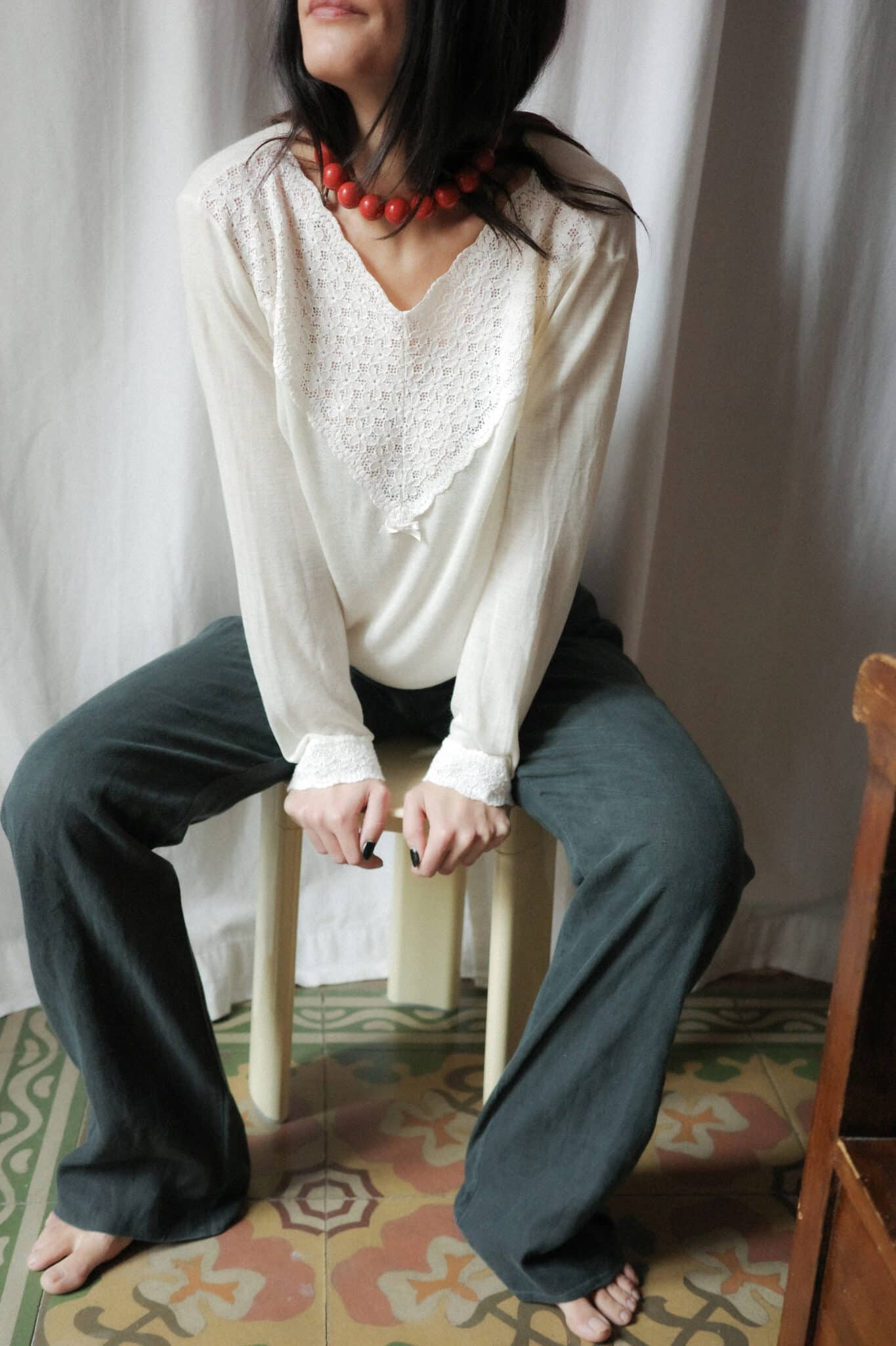 Soft cream long sleeve top with lace yoke styled with wide leg trousers