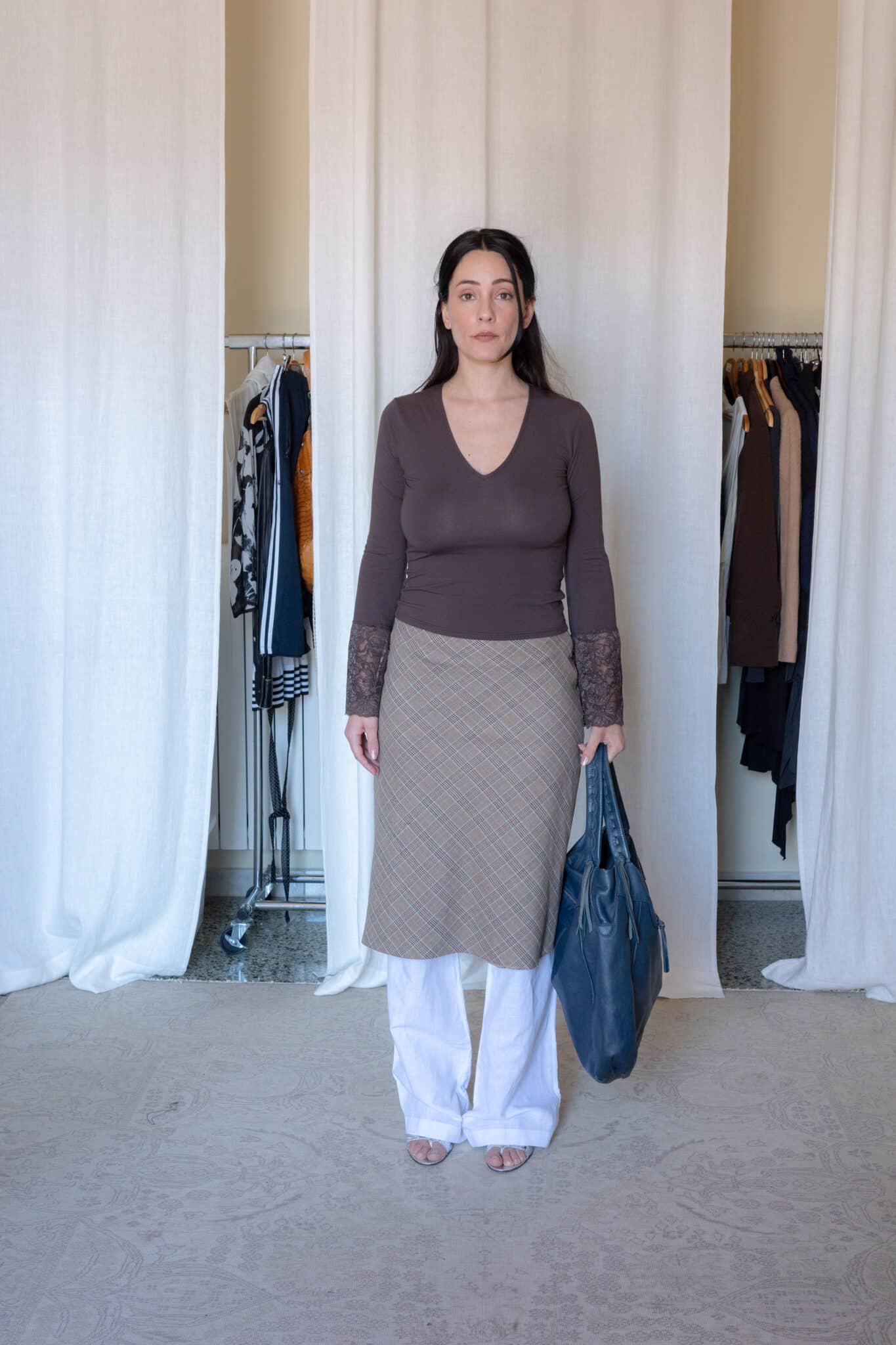 Brown fitted long sleeve top with a deep v-neckline and semi-sheer floral lace cuffs, designed in a soft stretch fabric with a close-fitting silhouette and minimal clean finish.