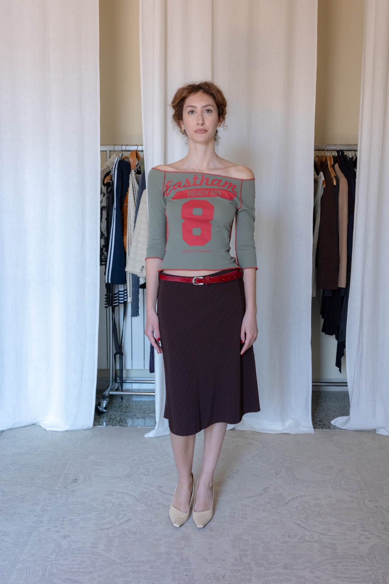 Off shoulder graphic top with red contrast stitching and cropped sleeves