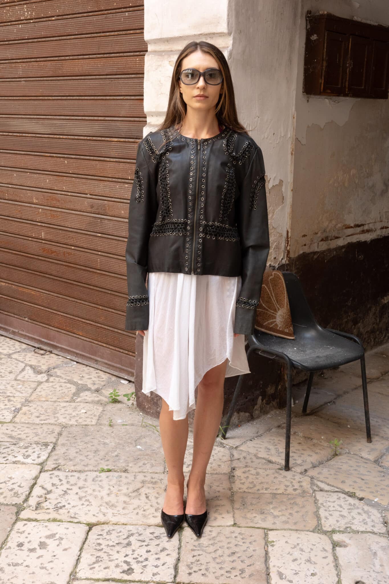 Black leather jacket with eyelet detailing and collarless neckline