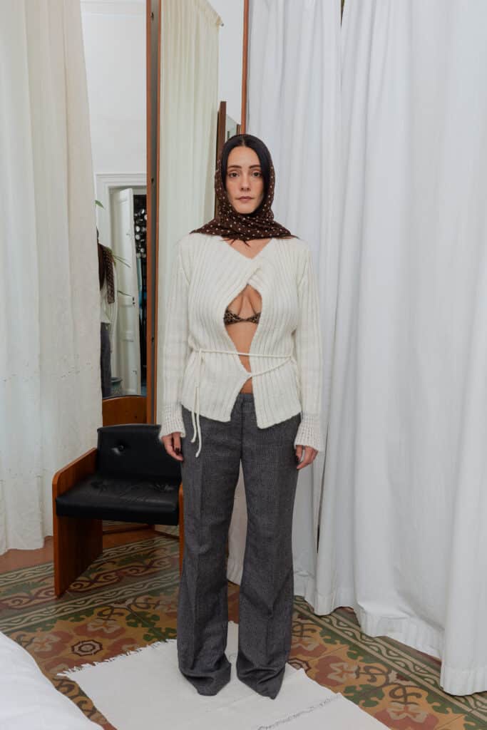 Full outfit featuring cream ribbed cardigan, grey check trousers and brown polka scarf in natural light.