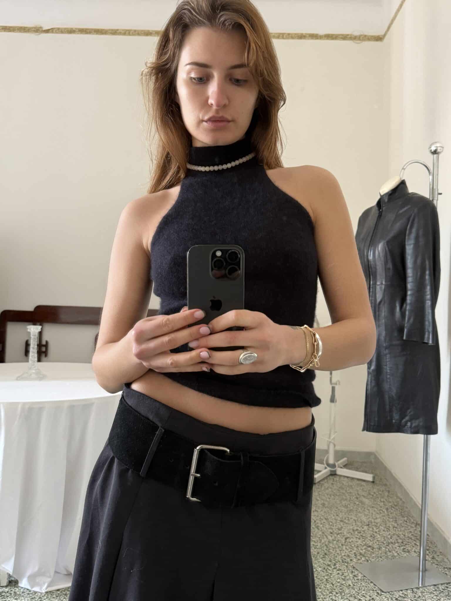 Black halter knit top with high neckline and pearl trim detail