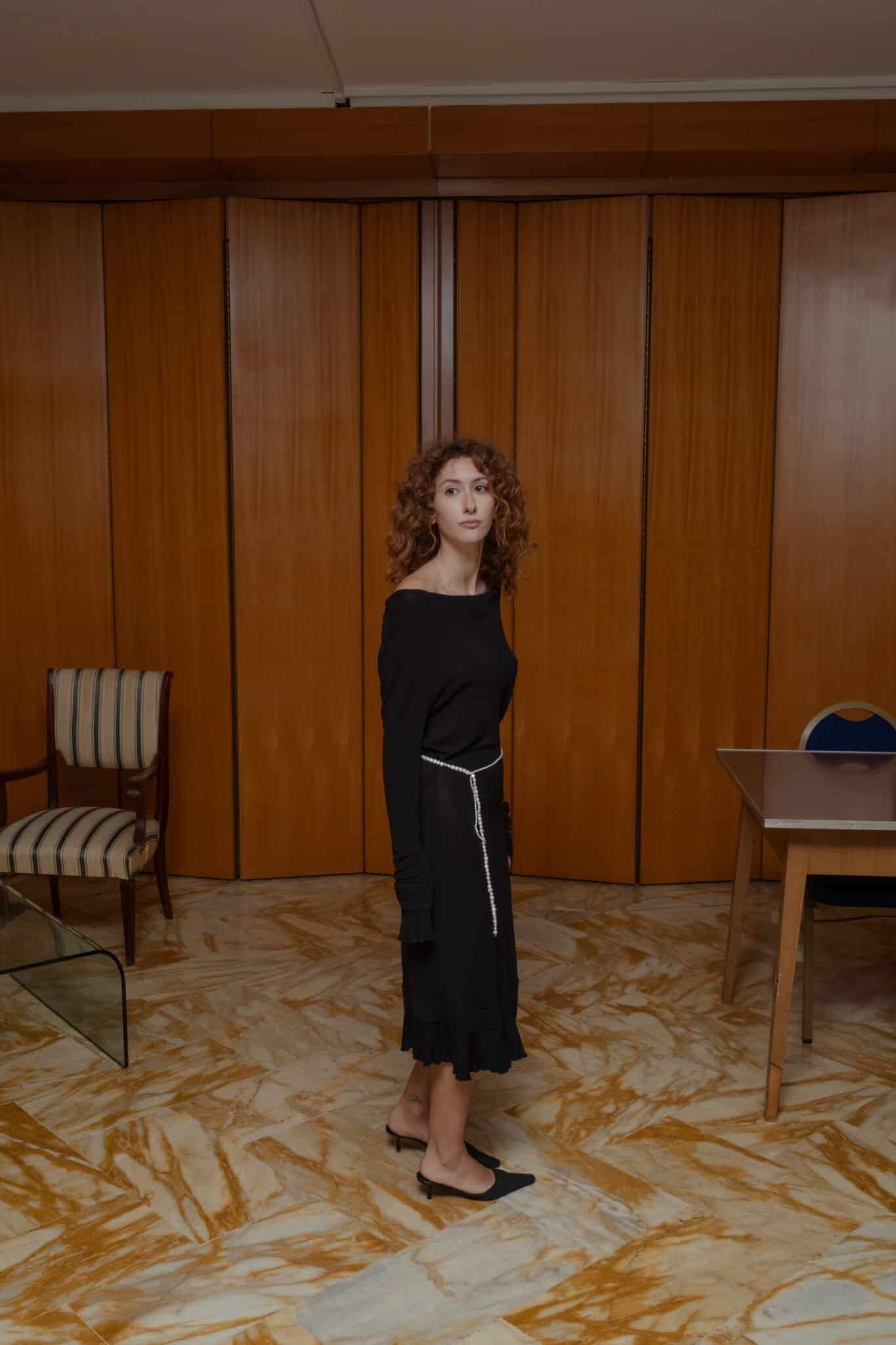 Fitted black off-shoulder midi dress with straight neckline