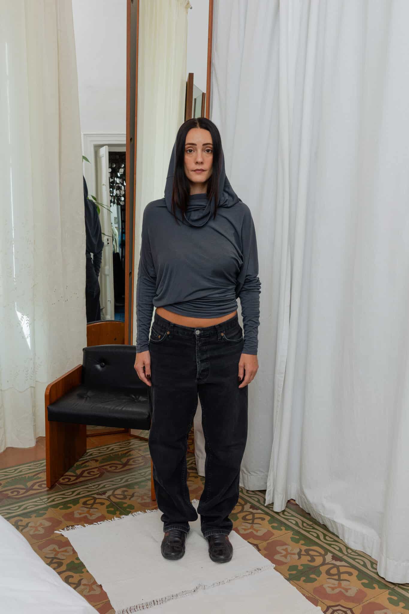 Side profile of hooded top showing soft fabric fall.