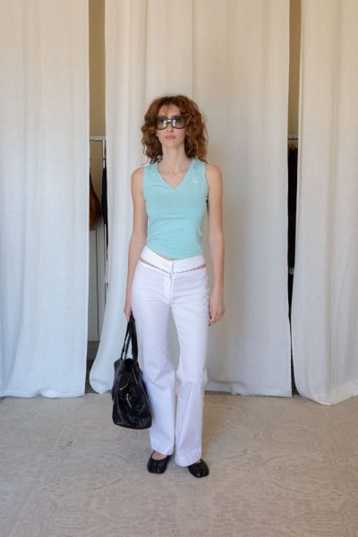 Side view of a fitted light blue Adidas tank top with clean seam detailing, soft stretch construction and a sleek sleeveless silhouette with a subtle v-neck shape.