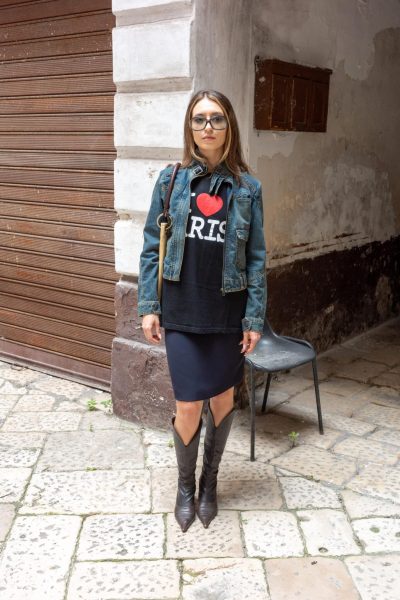 Structured denim outerwear styled with a navy knee-length skirt.