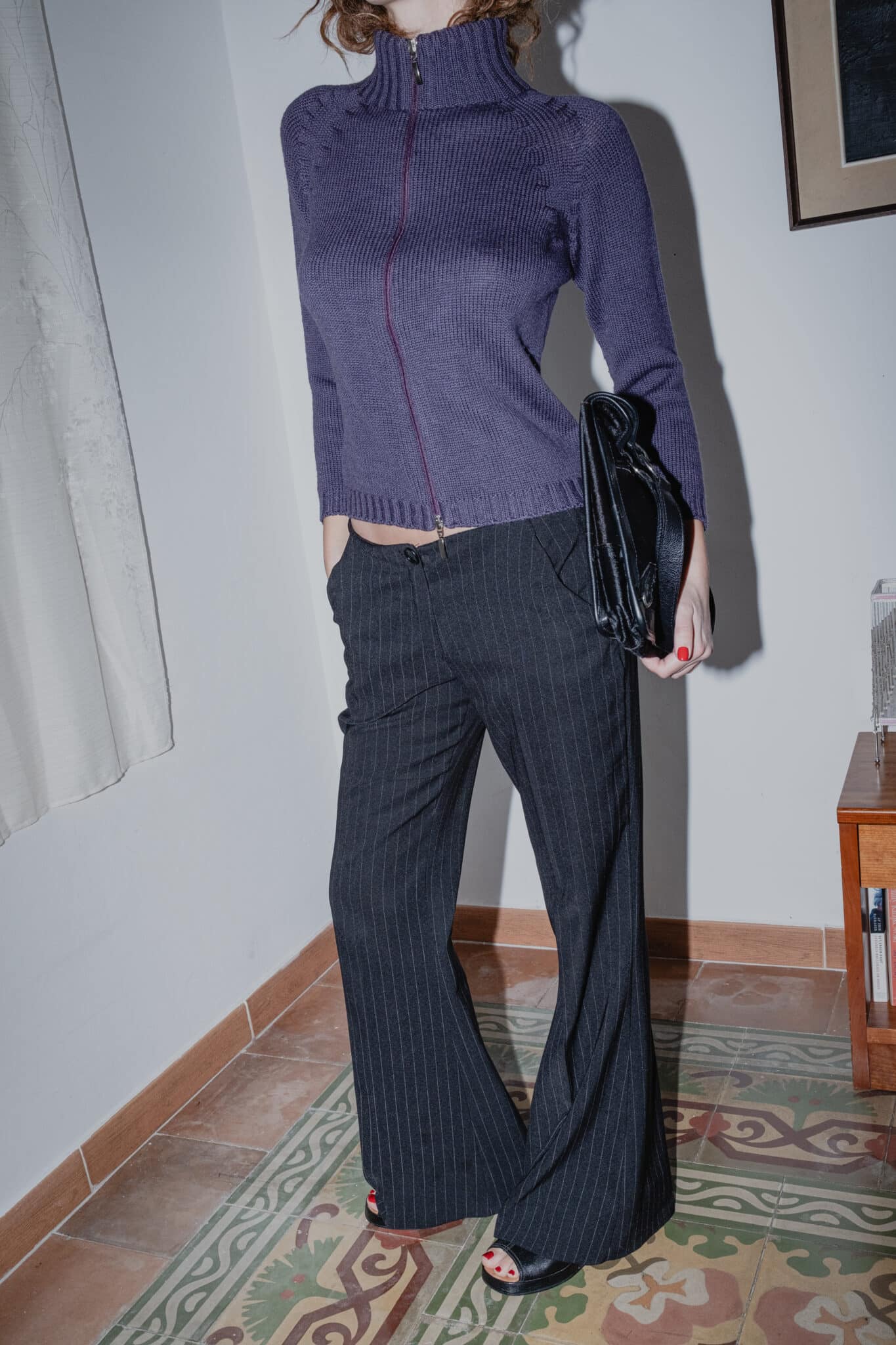 Ribbed wool high-neck sweater styled with long tailored pinstripe bottoms.
