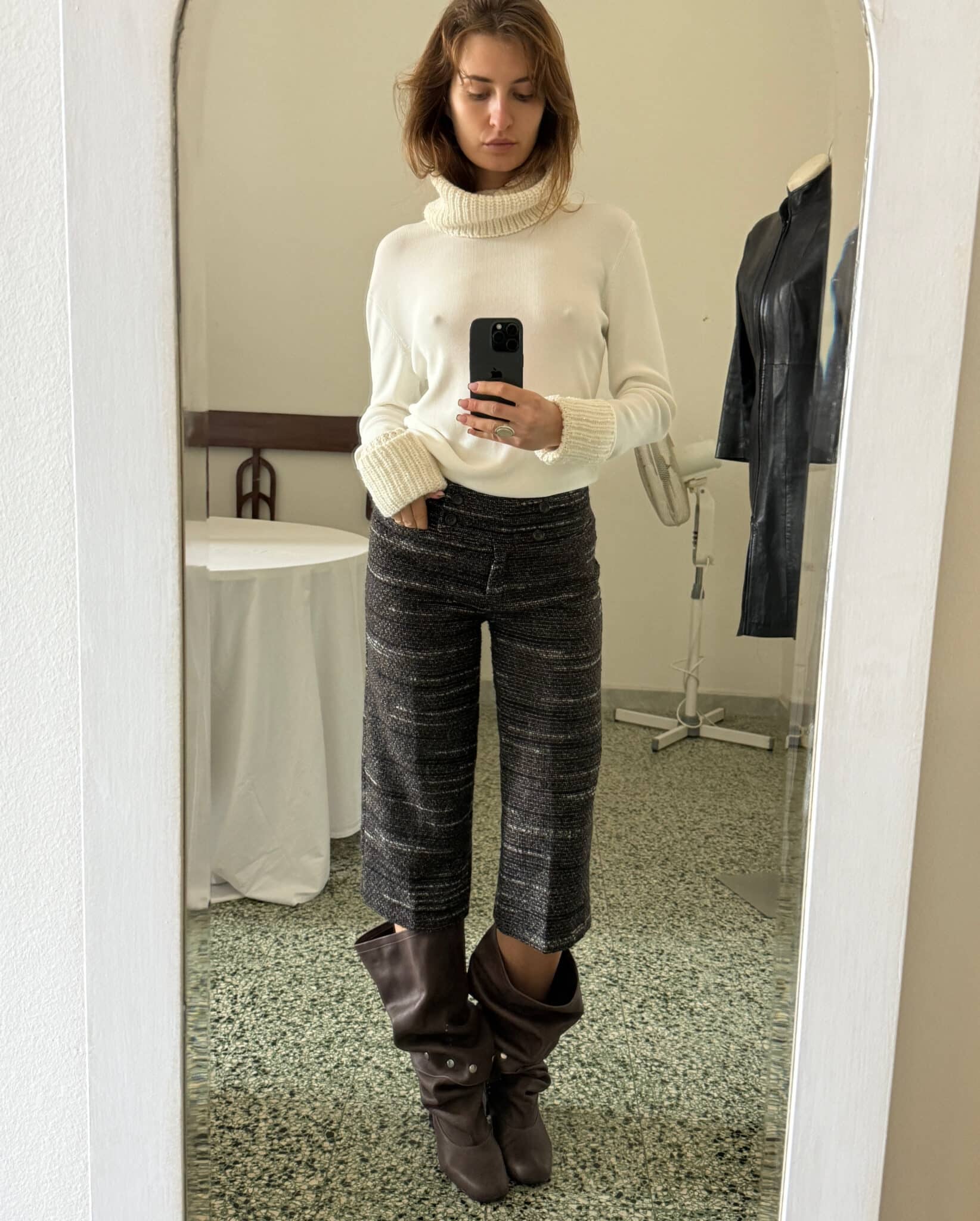 Ivory knit turtleneck top with subtle rhinestone detailing at collar and cuffs