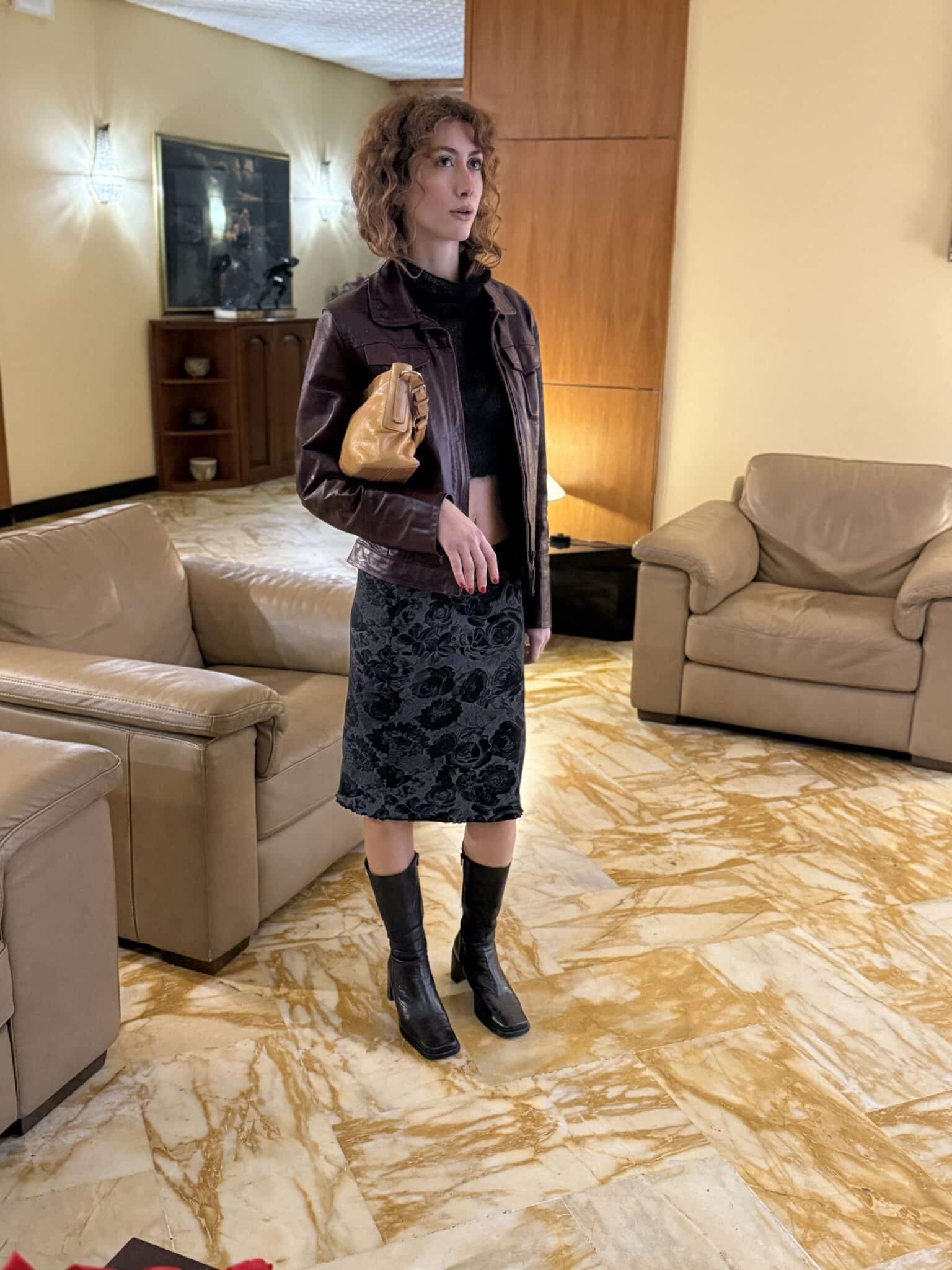 Midi skirt with floral texture paired with leather jacket and black boots