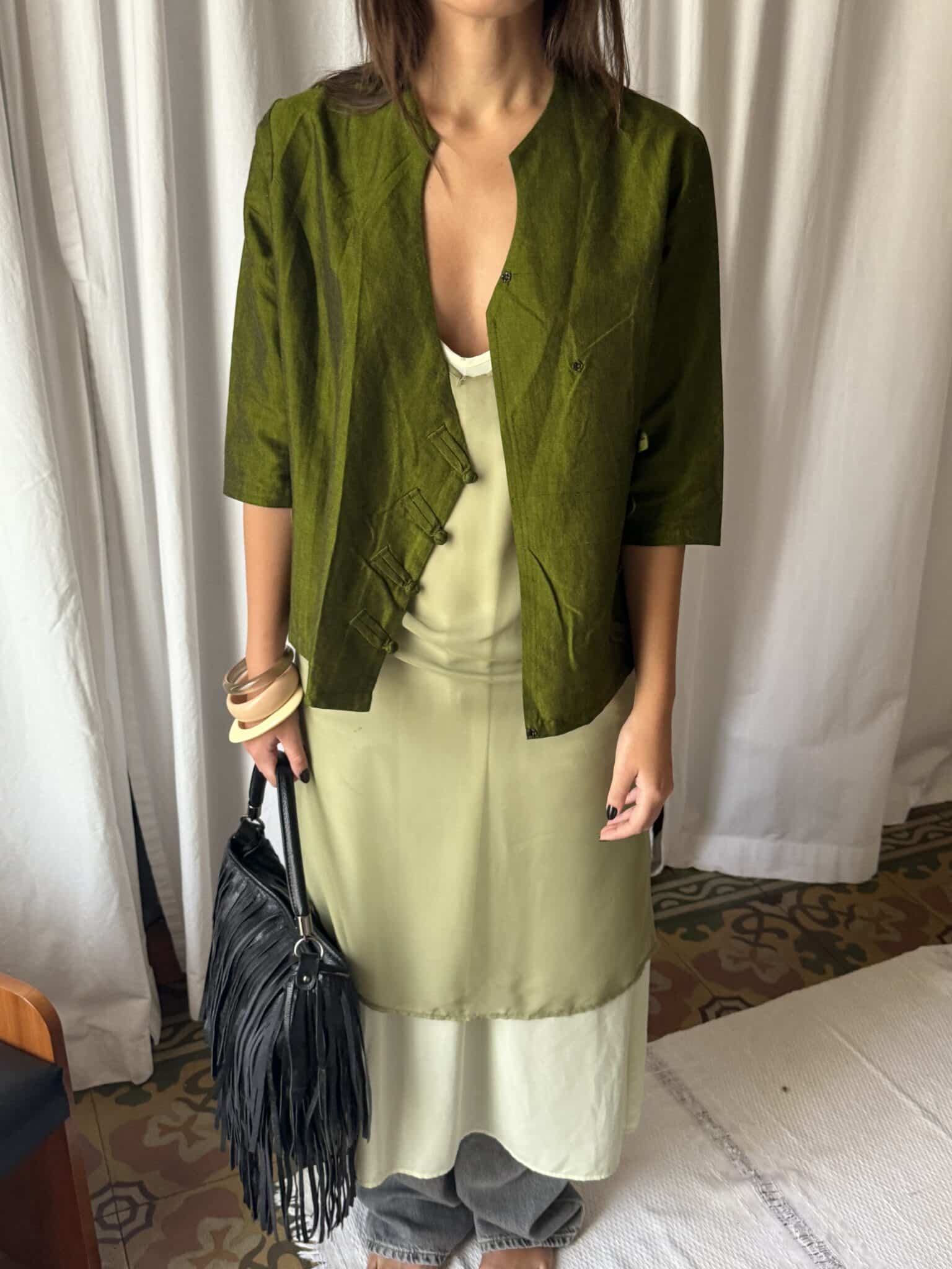 Front view of light green slip dress with thin straps and straight silhouette.