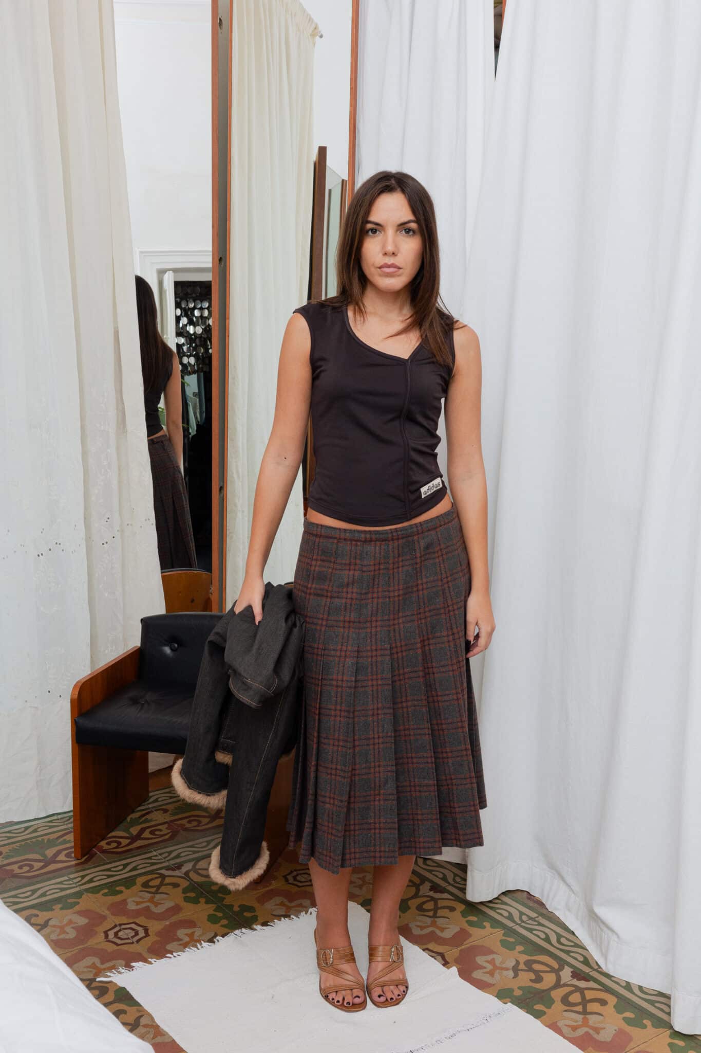 Brown and grey pleated skirt with structured drape.