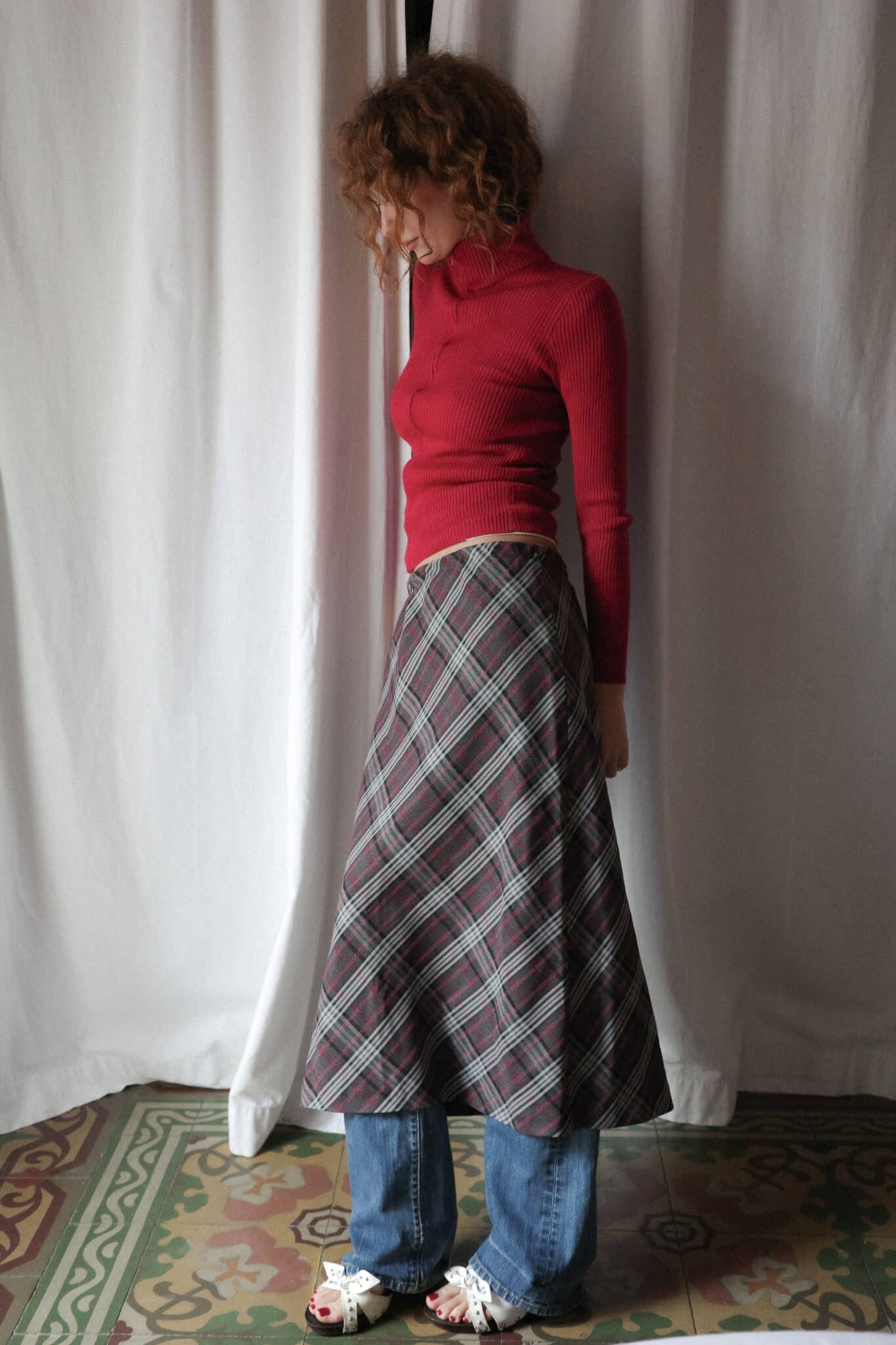 High-neck red knit top with visible zip closure