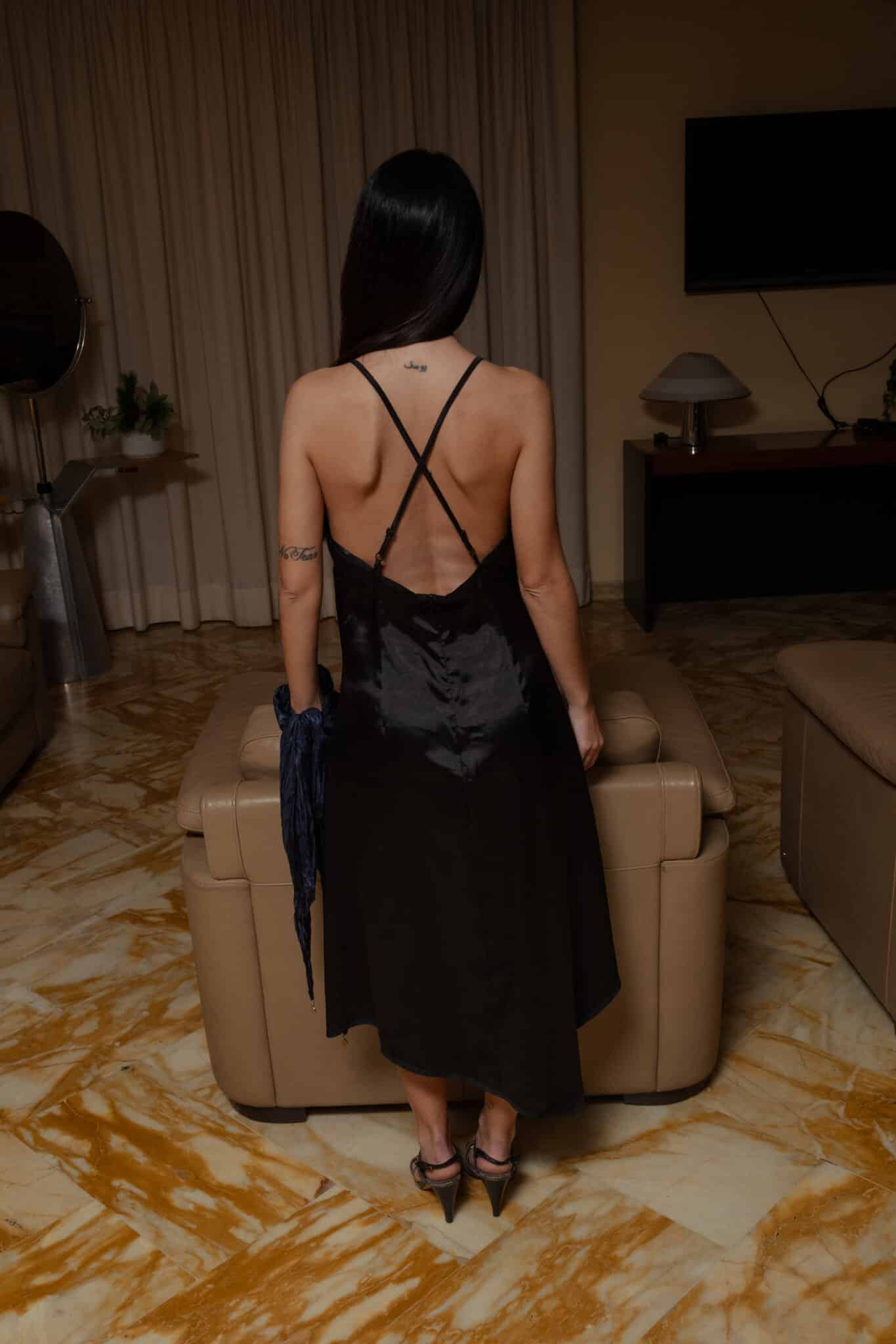 Black satin slip dress featuring an open crossed back