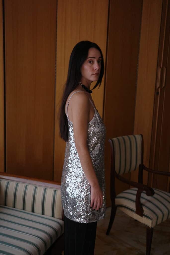 Relaxed-fit silver sequin top styled with black trousers