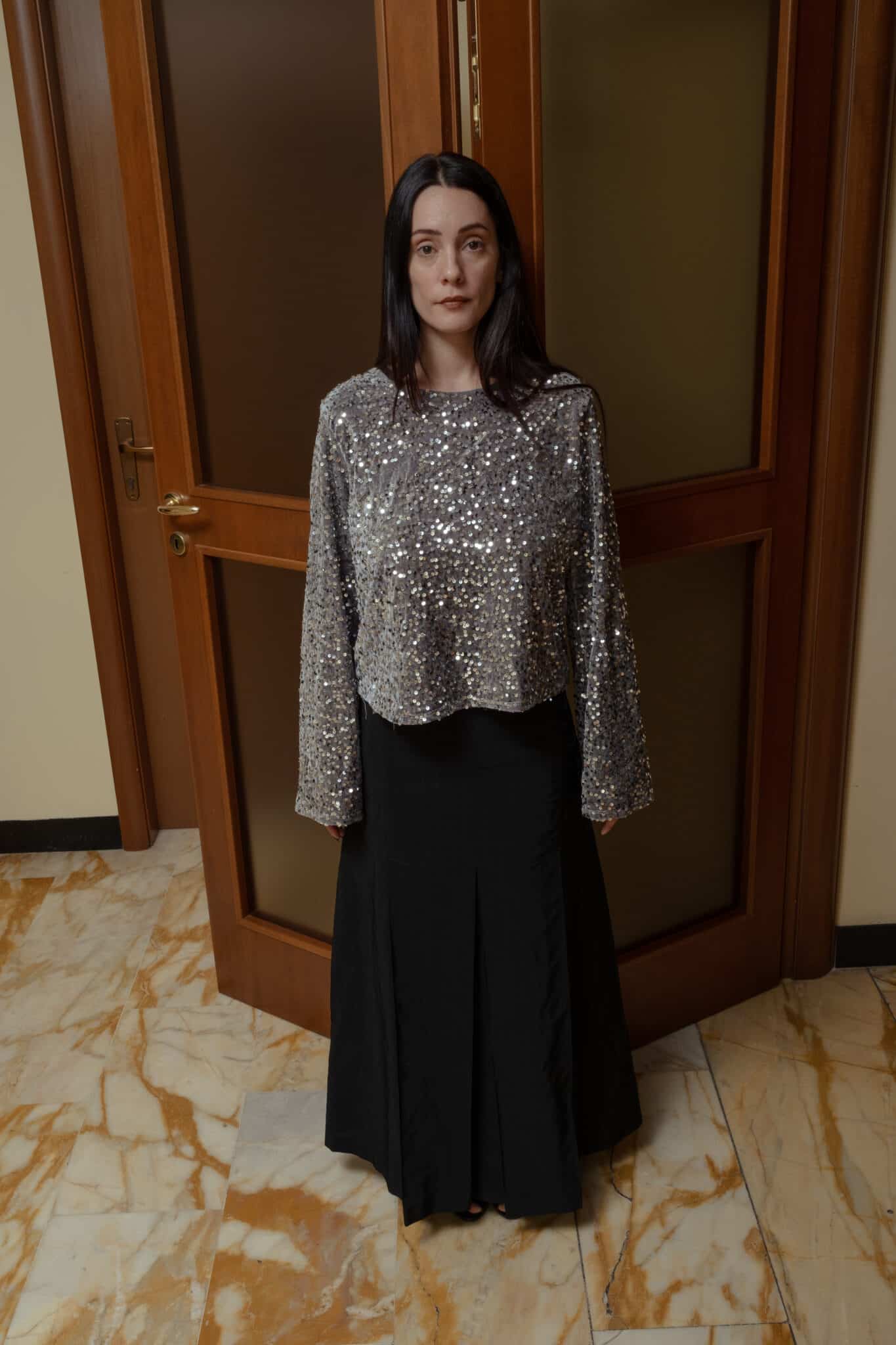 Silver sequin top combined with black wide leg pants